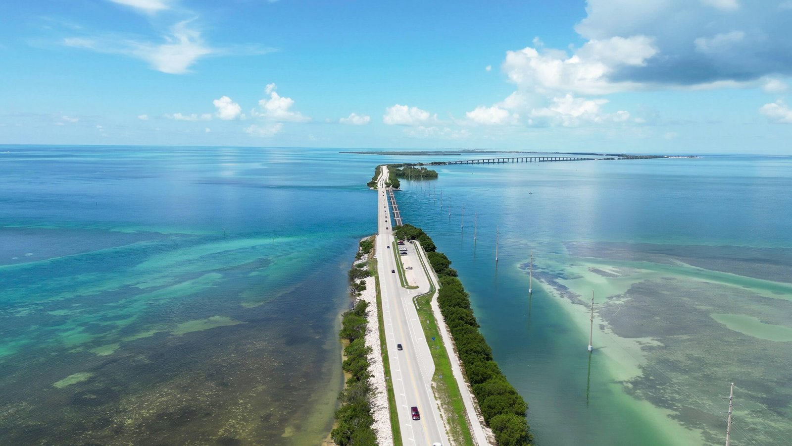 an aerial view of a long stretch of road next to the ocean